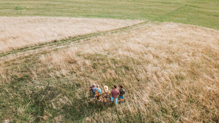 Aerial view of multigenerational family on hiking trip in nature.