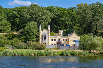 Obraz premium Boat trip in Potsdam: Small Babelsberg Castle in park Babelsberg, seen from the Havel river