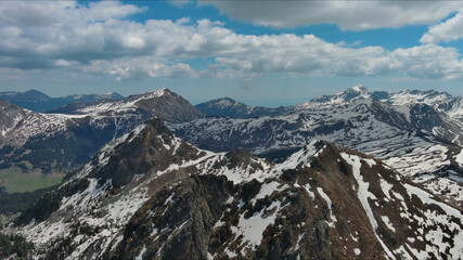 Rocky snow mountains before sunset aerial
