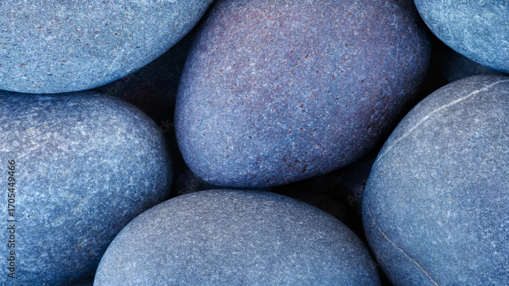 Poster group of beautiful blue round pebble stones close-up as textured abstract spa background for web ban