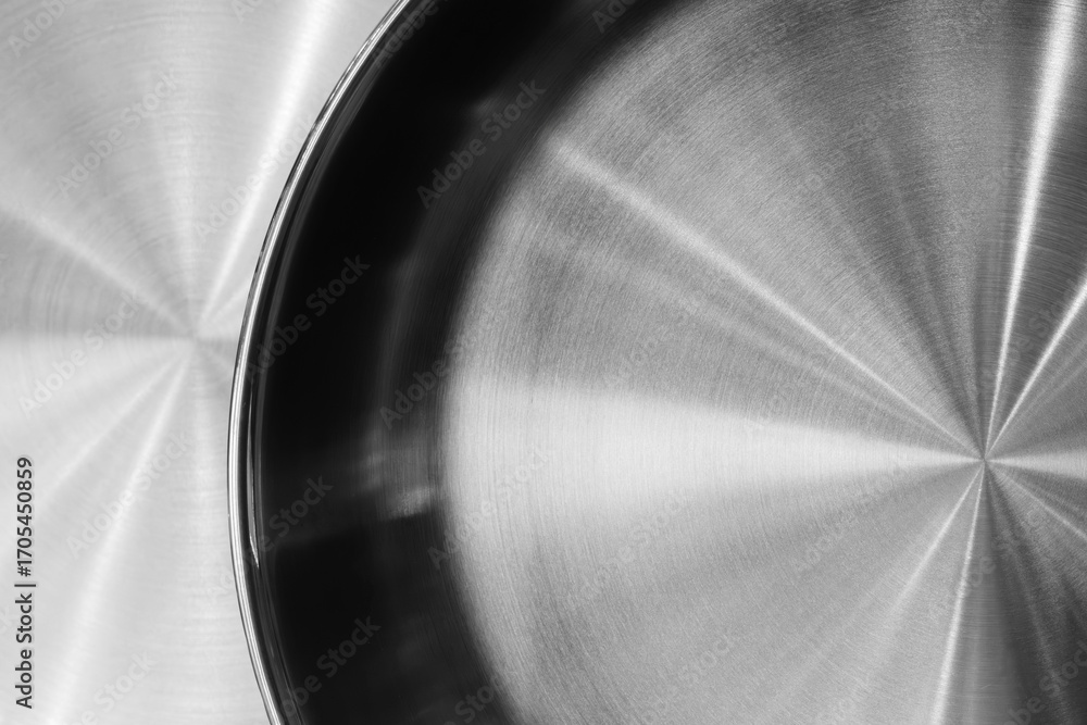Poster silver frying pan with black rim. the frying pan is shiny and has a smooth surface as an abstract me