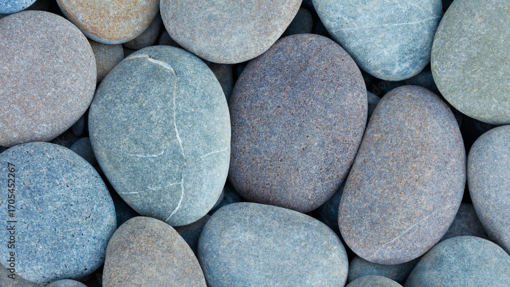 Poster pebbles stones on seashore as texture background for design web banner template page. many stones an