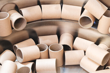 Many cardboard tubes in an industrial packaging machine.