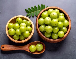 Fresh green berries in wooden bowls and spoon