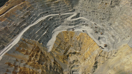 Aerial of open mine and heavy mining equipment