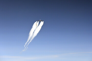 Aeroplane with contrails (condensation trails) or vapour trails; Line-shaped clouds produced by aircraft engine exhaust or changes in air pressure, typically at aircraft cruising altitud