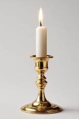 Single, white candle in a gold candlestick against a plain background