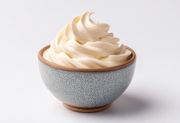 Creamy whipped topping in a small, light-gray bowl