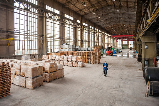 Businessman with tablet in old industrial warehouse hall