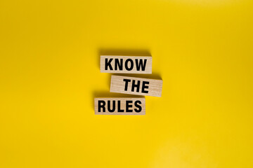 know the rules words on wooden blocks isolated on yellow background
