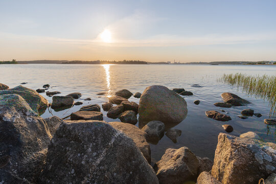 Amazing golden sunset seen from Ruissalo island over the Turku archipelago in south west Finland with a view on the boulders and rocky coastline with a natural view over the Baltic sea 