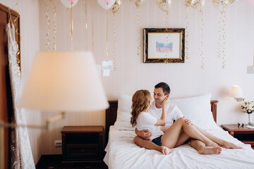 young couple bride and groom in the morning in a hotel room