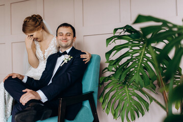 young couple bride and groom in a dark studio with a floor mirror