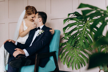 young couple bride and groom in a dark studio with a floor mirror