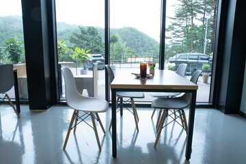Modern Cafe Table with Coffee and Pastry Near Window