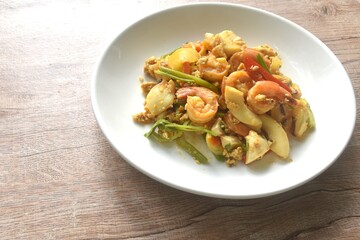 stir-fried spicy squid with shrimp salty egg and sauce on plate