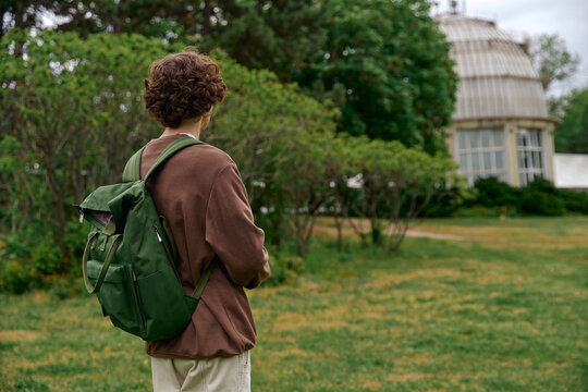 Young man enjoys a peaceful walk in a beautiful outdoor setting surrounded by nature - Powered by Adobe