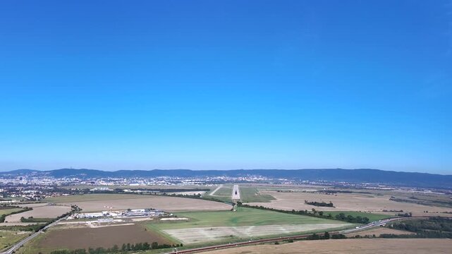 An immersive pilot&rsquo;s FPV perspective of a sigle airport runway, under a blue sky, in a bright summer morning. ultra-realistic 4K