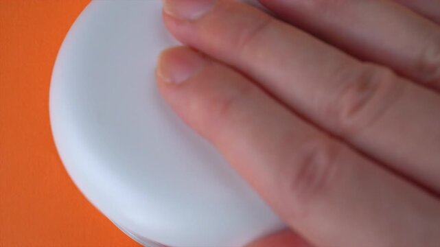  Opening White and Orange Dental Aligner Case that are Orthodontic Mouthpiece storage in orange background. Slow motion.