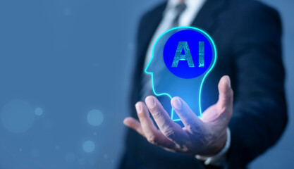 Hand holding a glowing holographic human head with an AI brain, symbolizing future intelligence.