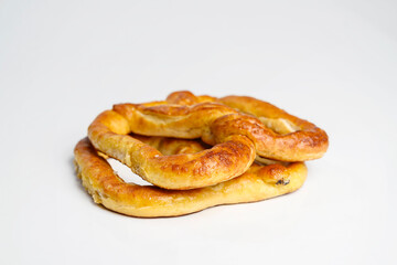Salty baked brown pretzel isolated over a white background. Oktoberfest festival