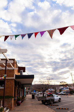 bunting hanging over footpath alongside street in country town of Merriwa