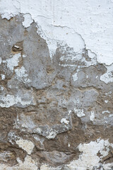 Old cracked wall texture with peeling plaster close-up