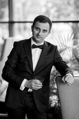 portrait of groom in blue tuxedo in hotel