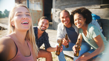 Group Of Friends Drinking Beer Posing For Selfie On Mobile Phone On Vacation Hiking In Countryside