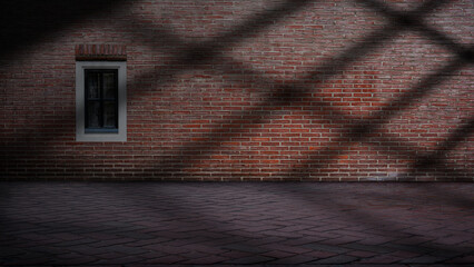 Dramatic shadow of window light shines across the interior of the room with red brick walls and a tile floor. Mockup, copy space, or template. Empty backdrop podium for product or text display