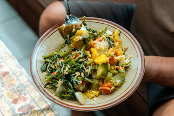 Close-up of a traditional Indonesian healthy dish with fresh vegetables, corn, bean sprouts, and greens. Nutritious homemade food concept, perfect for diet, organic lifestyle, and local cuisine.
