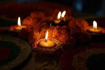 Festive Lights. Close-up of oil lamps and marigold flowers for Diwali celebration.
