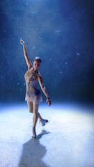 Naklejka premium Graceful female skater performing on frozen stage with emotional expression. Concept of art performance, beauty culture, fitness strength, romance, spirituality in motion.