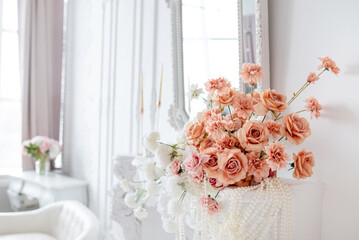 artificial roses in the interior decor. Beautiful arrangement of soft pink roses in a decorative vase, enhancing interior decor with elegance and charm