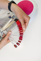 A professional carefully presents nail polish options to a client, enhancing the manicure experience in a beauty salon