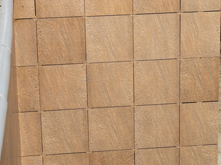 Wooden cube mosaic creates a geometric pattern. A natural wood texture for interior design backgrounds.