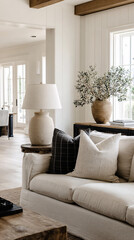 Fototapeta premium Front view of a modern sofa and sideboard with a textured stone lamp in a bright living room interior design setting