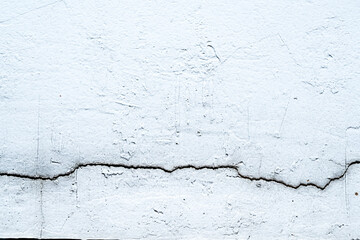 Grey cement concrete wall grunge background design. Abstract plaster textured with scratches and cracks for wallpaper or copy space