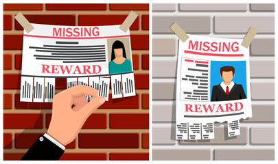 Hand tearing off a slip from a missing person reward poster for a woman on a brick wall, with a missing man poster nearby. Lost person search concept.