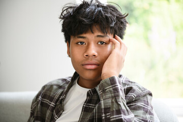 portrait young handsome thai boy on sofa