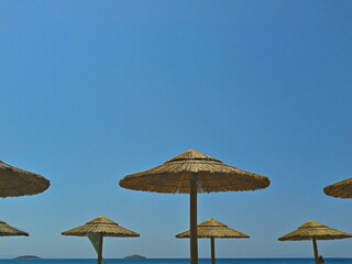 Beach Umbrellas on a Sunny Day with Clear Blue Sky and Sea