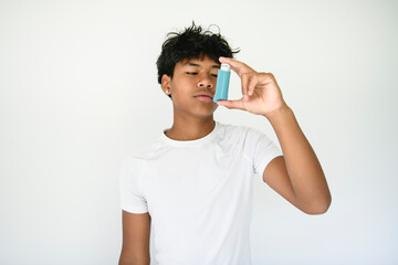 A teen having an asthma problem in studio gray