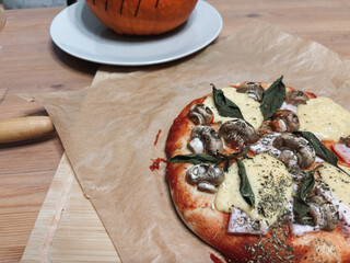 Preparation the table for Halloween. Homemade pizza with mushroom skulls. High quality photo