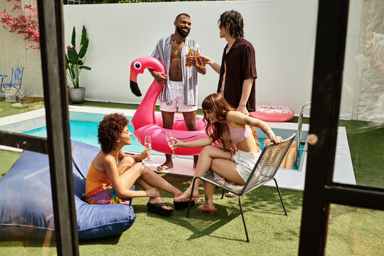 Stylish friends enjoying laughter and drinks at a vibrant summer pool party with a flamingo float