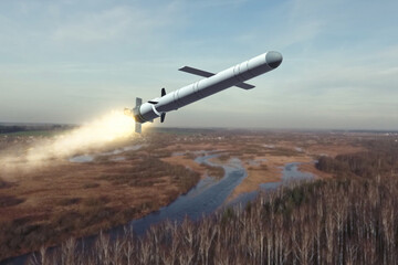 A Russian cruise missile is flying over a river valley, the tail flame from the engine.