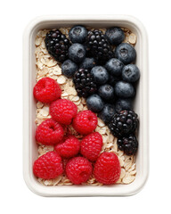 A topdown view of a healthy breakfast bowl filled with fresh raspberries, blackberries, and blueberries served over rolled oats, isolated on a transparent background