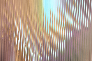 Obraz premium Abstract pattern of vertical lines with a gradient of warm brown to cool blue and purple hues, creating a sense of depth and movement