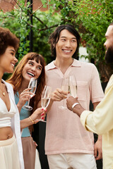 Joyful gathering of friends at a sunny outdoor cafe enjoying sparkling drinks together