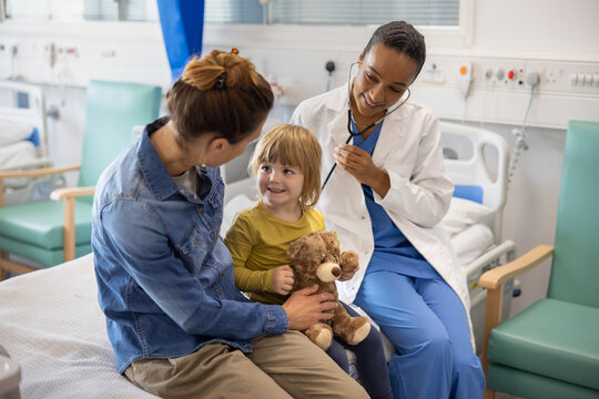 Child with Teddy Bear at Hospital Checkup Visit - Powered by Adobe