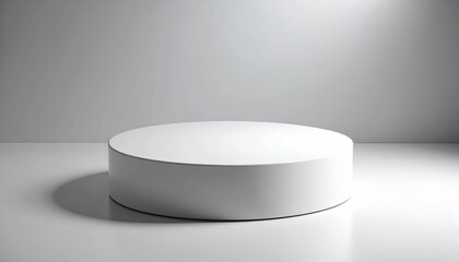 A simple, round, white pedestal sits elegantly against a plain gray backdrop, casting subtle shadows on a reflective white floor.